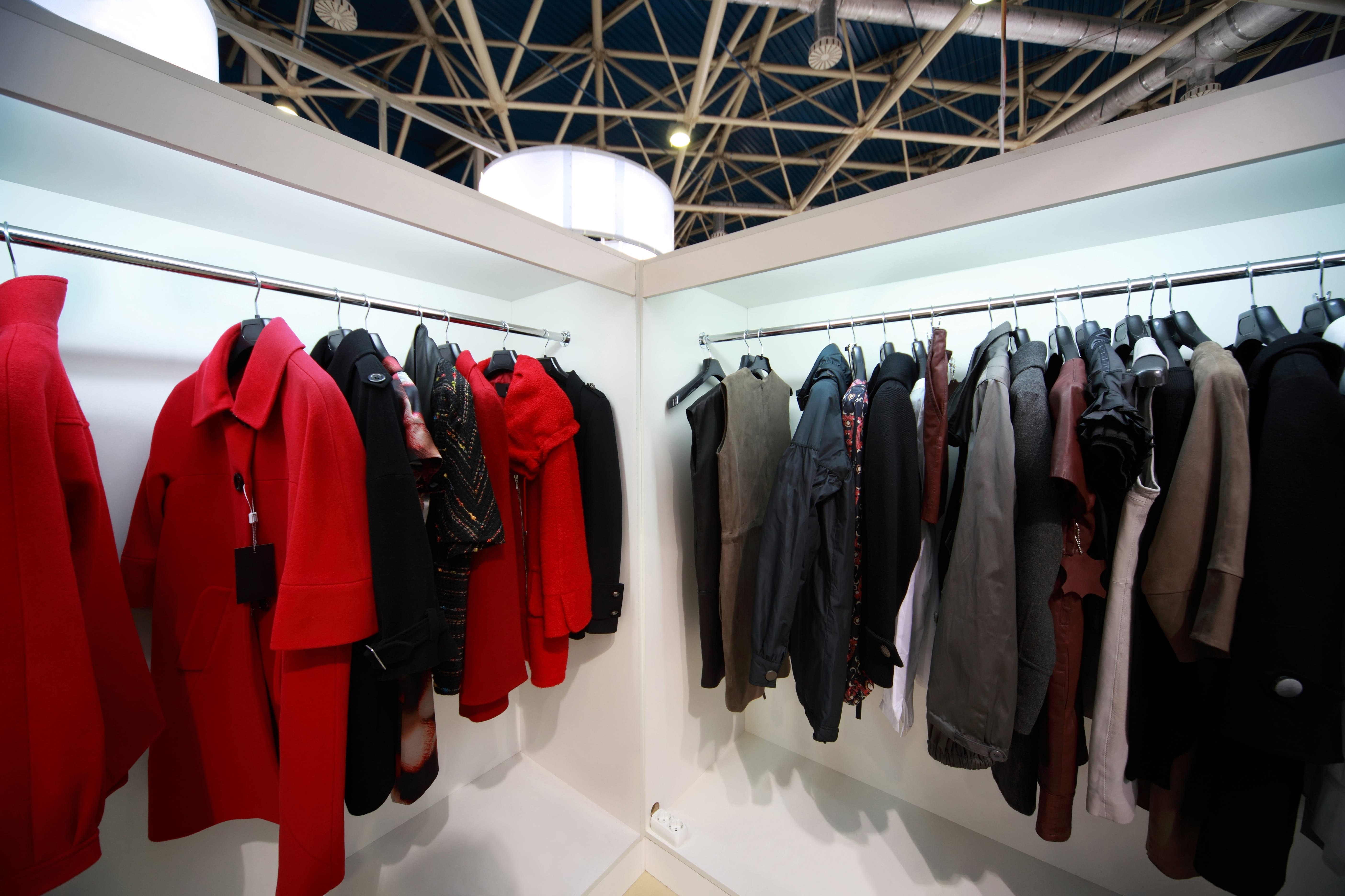 Firm outer clothing hangs at demonstration stands in showroom