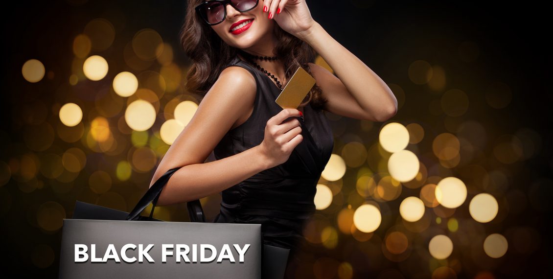 Shopping woman holding grey bag on new year background with lights bokeh in black friday holiday